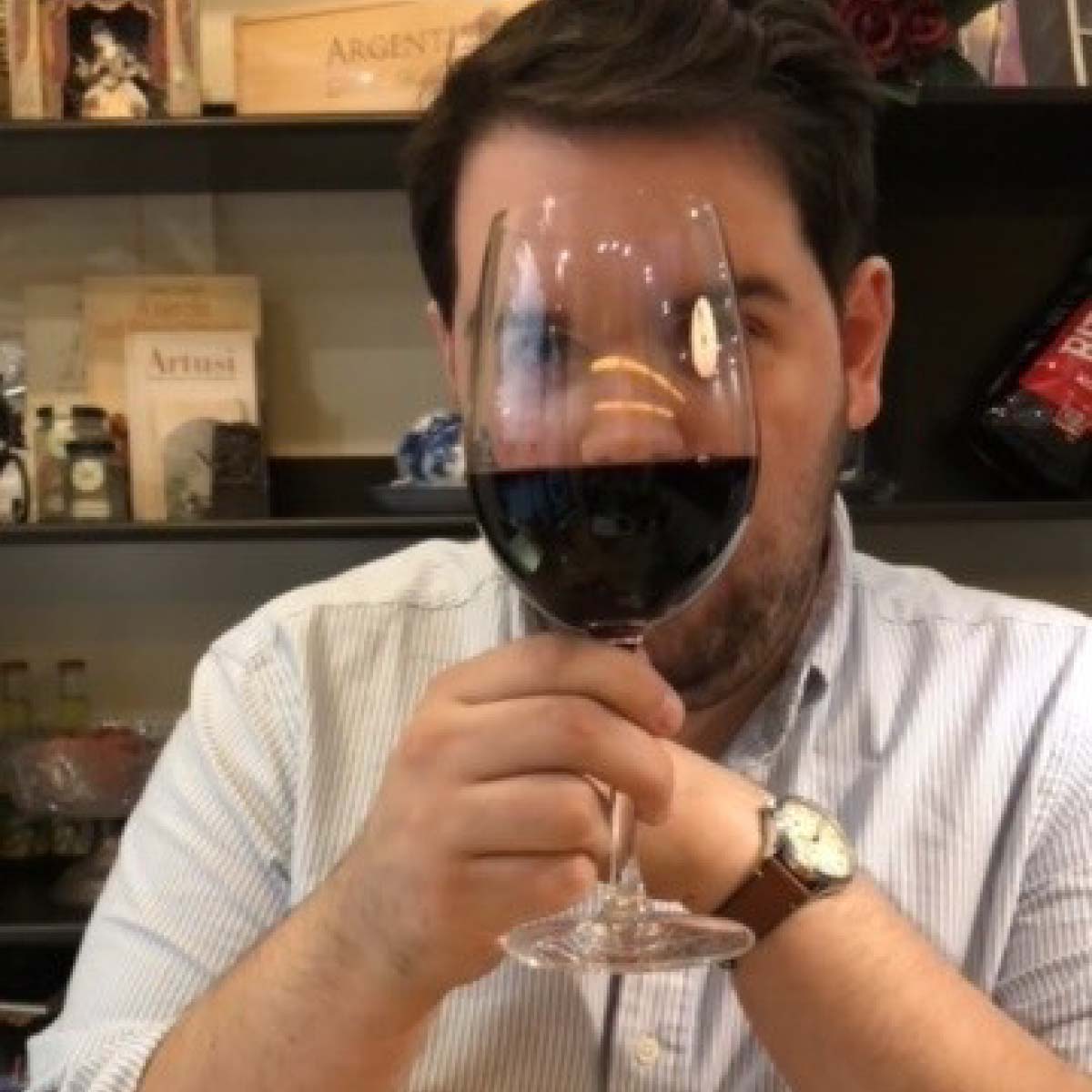 Parker James. Man with wine glass in front of his face